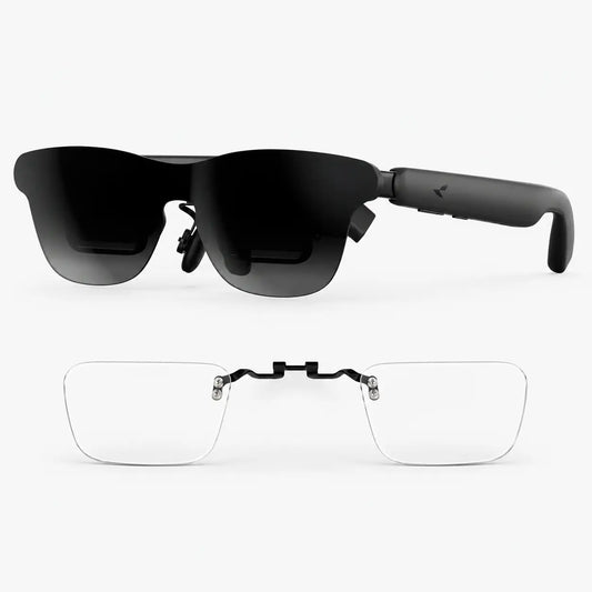Black smart glasses with dark tinted lenses shown from the front, with a second pair of clear rimless eyeglasses attached via a black bridge, on a light gray background.